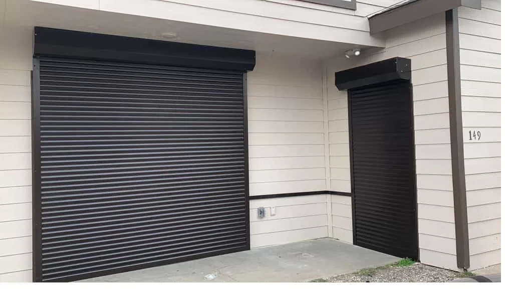 Black roll-down shutters on residential home